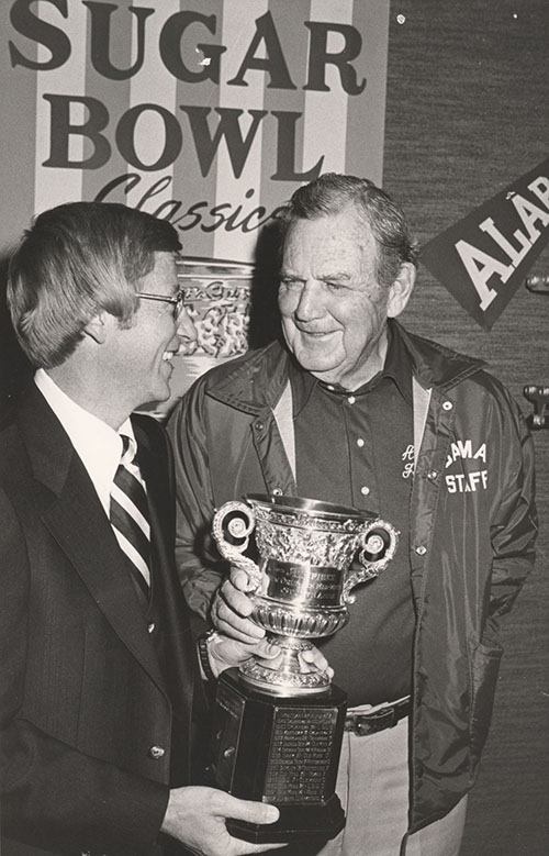 Coaches Paul Bryant and Lou Holtz hold Sugar Bowl trophy