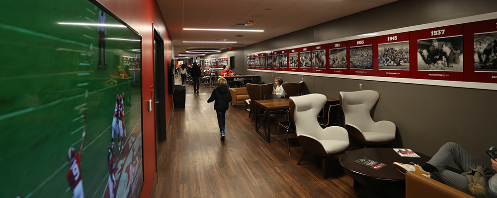 Large hallway with seating groups and artwork showcasing National Championships won
