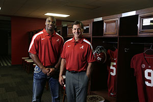 Demeco Ryans and Johnny Musso standing in front of football lockers
