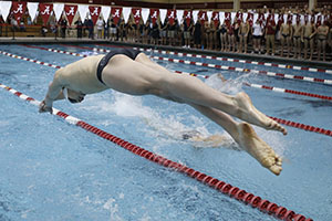 male swimmer diving into lane